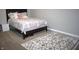 Cozy bedroom featuring a patterned bedspread and a plush area rug at 2599 Liatris Dr, Plainfield, IN 46168