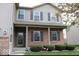 Charming brick home with a covered front porch and well-manicured landscaping featuring hedges and decorative pink flamingos at 2599 Liatris Dr, Plainfield, IN 46168