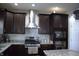 This kitchen features granite countertops, stainless steel appliances, modern cabinets and tiled backsplash at 2599 Liatris Dr, Plainfield, IN 46168