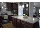 A modern kitchen featuring granite countertops, stainless steel appliances, a large island and plenty of cabinet space at 2599 Liatris Dr, Plainfield, IN 46168