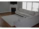 A bright living room with hardwood floors, a large window, a comfortable sofa and a fireplace at 2599 Liatris Dr, Plainfield, IN 46168