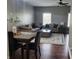 Open concept living room with hardwood floors, large windows, comfortable seating, a decorative rug and a ceiling fan at 2599 Liatris Dr, Plainfield, IN 46168
