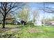 Picturesque backyard showcasing mature trees, a playhouse, and additional buildings at 30 Sleepy Hollow Ct, Westfield, IN 46074