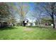 Expansive backyard featuring lush greenery, a small treehouse, and outbuildings at 30 Sleepy Hollow Ct, Westfield, IN 46074
