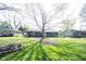 Spacious backyard featuring a large tree, deck and fire pit, perfect for outdoor entertaining and relaxation at 30 Sleepy Hollow Ct, Westfield, IN 46074