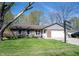 Charming brick home with a well-manicured lawn, front porch, two-car garage, and basketball hoop at 30 Sleepy Hollow Ct, Westfield, IN 46074