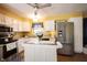 Bright eat-in kitchen features stainless steel appliances, white cabinets, and tile island at 30 Sleepy Hollow Ct, Westfield, IN 46074
