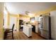 Bright kitchen featuring white cabinets, stainless steel appliances, central island, and wood-look flooring at 30 Sleepy Hollow Ct, Westfield, IN 46074
