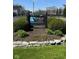 A welcoming Heron Lake condominium sign with lush landscaping at 3010 Lake Shore Dr # D, Indianapolis, IN 46205