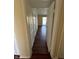 Hallway featuring hardwood floors, neutral walls, and a glimpse of the outdoor balcony at 3010 Lake Shore Dr # D, Indianapolis, IN 46205