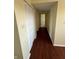 Inviting hallway with hardwood floors and neutral paint, leading to other rooms at 3010 Lake Shore Dr # D, Indianapolis, IN 46205