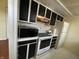 Compact kitchen featuring white appliances, and black and white cabinets at 3010 Lake Shore Dr # D, Indianapolis, IN 46205