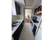 Efficient galley kitchen showcasing white appliances and countertops at 3010 Lake Shore Dr # D, Indianapolis, IN 46205