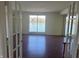 Spacious living room with hardwood floors and a large window view of the lake at 3010 Lake Shore Dr # D, Indianapolis, IN 46205