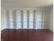 Living room featuring elegant built-in bookshelves and hardwood floors at 3010 Lake Shore Dr # D, Indianapolis, IN 46205