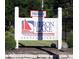 Private Heron Lake Condominiums sign with sailboat and lake in front of a wooded area at 3010 Lake Shore Dr # D, Indianapolis, IN 46205
