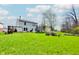 Spacious backyard with lush green grass, mature tree and recreational equipment for outdoor enjoyment at 3038 Arrowroot Ln, Indianapolis, IN 46239