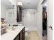 A functional bathroom with a sink, toilet, shower, and a glimpse into a walk-in closet for convenient storage at 3038 Arrowroot Ln, Indianapolis, IN 46239