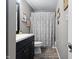Bathroom with a vanity, tile floors, and decorative shower curtain at 3038 Arrowroot Ln, Indianapolis, IN 46239