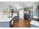 Charming kitchen featuring gray cabinets, stainless appliances, and wood floors at 3038 Arrowroot Ln, Indianapolis, IN 46239