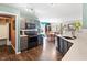 Well-lit kitchen with stainless steel appliances, quartz countertop, and wood flooring at 3038 Arrowroot Ln, Indianapolis, IN 46239
