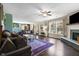Open-concept living room with a fireplace, large windows, and stylish furnishings at 3038 Arrowroot Ln, Indianapolis, IN 46239