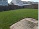 Large fenced backyard with lush green grass and patio at 3097 Limber Pine Dr, Whiteland, IN 46184