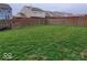 Large, flat backyard features a green lawn and a wooden privacy fence, great for outdoor activities and relaxation at 3097 Limber Pine Dr, Whiteland, IN 46184