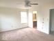 Spacious bedroom with a ceiling fan, neutral walls, carpet floors, and a view of the exterior at 3097 Limber Pine Dr, Whiteland, IN 46184
