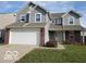 Charming two-story home featuring a spacious garage, neutral siding and brick accents at 3097 Limber Pine Dr, Whiteland, IN 46184