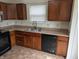 Functional kitchen area with wood cabinets, stainless steel sink, and black dishwasher at 3097 Limber Pine Dr, Whiteland, IN 46184
