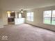 Bright living room featuring an open floor plan, large windows, and neutral carpet, offering a comfortable living space at 3097 Limber Pine Dr, Whiteland, IN 46184