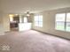 Bright living room featuring an open floor plan, large windows, and neutral carpet, offering a comfortable living space at 3097 Limber Pine Dr, Whiteland, IN 46184
