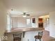 Spacious living room area with a ceiling fan, bar seating, and connecting rooms that create an inviting gathering spot at 3097 Limber Pine Dr, Whiteland, IN 46184