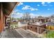 Balcony view featuring white railings and neighborhood views with blue sky and mature trees at 3140 N Washington Blvd, Indianapolis, IN 46205