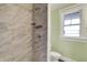 New bathroom features walk-in shower with tiled surround and window at 3140 N Washington Blvd, Indianapolis, IN 46205