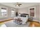 Bedroom with wood floors, ceiling fan and windows with natural light at 3140 N Washington Blvd, Indianapolis, IN 46205