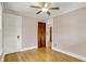 Neutral bedroom features a ceiling fan, a closet, and hardwood floors at 3140 N Washington Blvd, Indianapolis, IN 46205