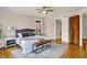Bedroom features a ceiling fan, wood floors, and bed with a gray headboard at 3140 N Washington Blvd, Indianapolis, IN 46205