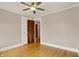 Neutral bedroom with hardwood floors, closet, and door to connecting room at 3140 N Washington Blvd, Indianapolis, IN 46205
