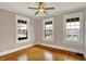 Bright, airy room features hardwood floors and three large windows at 3140 N Washington Blvd, Indianapolis, IN 46205