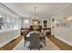 Elegant dining room with chandelier, built-in bench, and large windows at 3140 N Washington Blvd, Indianapolis, IN 46205