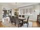 Dining room with a large table, hardwood floors, and a view to the living room at 3140 N Washington Blvd, Indianapolis, IN 46205