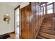 Classic hallway with wooden staircase, detailed trim, and a glimpse into adjacent rooms, adding character to the home at 3140 N Washington Blvd, Indianapolis, IN 46205
