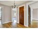 Hallway features hardwood floors, white trim, and doorway at 3140 N Washington Blvd, Indianapolis, IN 46205