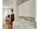 Practical laundry area with modern appliances and convenient storage, blending functionality with the home's classic charm at 3140 N Washington Blvd, Indianapolis, IN 46205