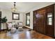 Inviting living room with hardwood floors, a decorative light fixture, and neutral decor at 3140 N Washington Blvd, Indianapolis, IN 46205