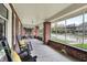 Inviting screened porch with brick detailing, classic rocking chairs, and ample natural light at 3140 N Washington Blvd, Indianapolis, IN 46205
