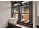 Cozy window seat with plush cushions, offering a comfortable spot with natural light and neighborhood views at 3140 N Washington Blvd, Indianapolis, IN 46205