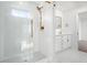 Updated bathroom with white herringbone tile in the shower and white and black tile floors at 3316 Eden Way Cir, Carmel, IN 46033